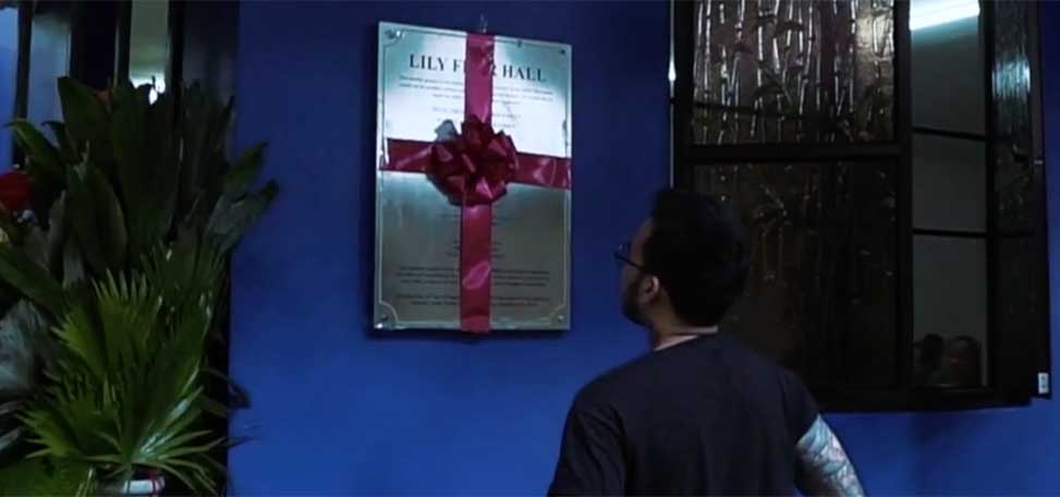person look at a plaque commemorating the memory of lily flor the first virtual assistant
